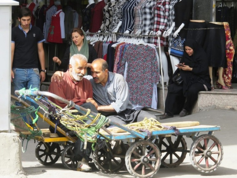Мужчины болтают друг с другом на большом базаре в Тегеране